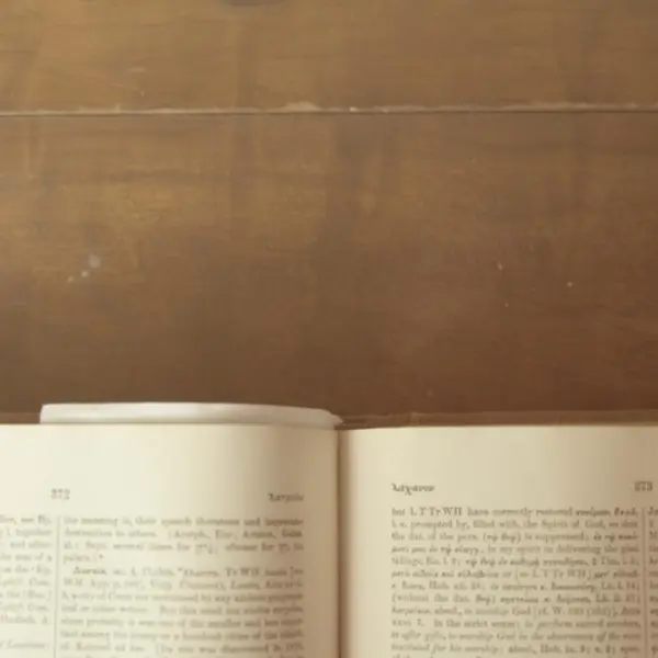 An open Bible on a wooden table