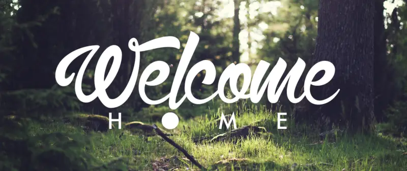 Welcome Home, written over a sunlit forest